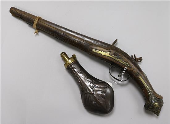 A late 18th century Turkish flintlock pistol and a copper powder flask	 48cm. & 20cm.